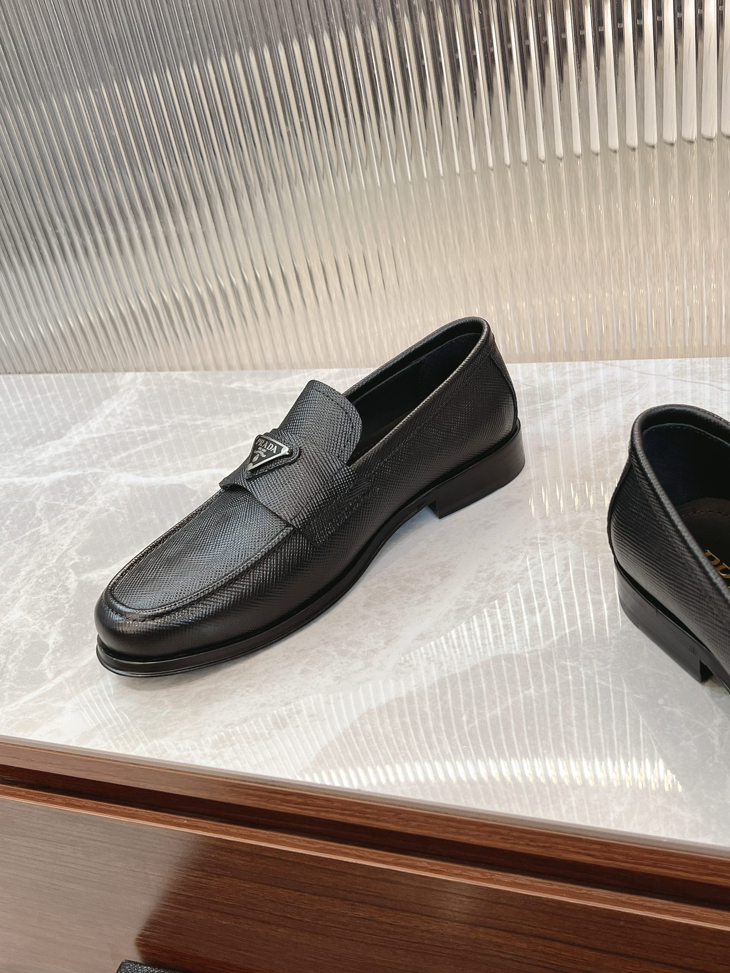 Prada unisex loafers, dark textured leather with strap, low heel and side metal logo