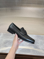 Prada unisex loafers in dark textured leather, lifted side view of loafer upper