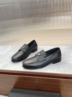 Prada unisex loafers in dark textured leather, metal logo badge on the strap