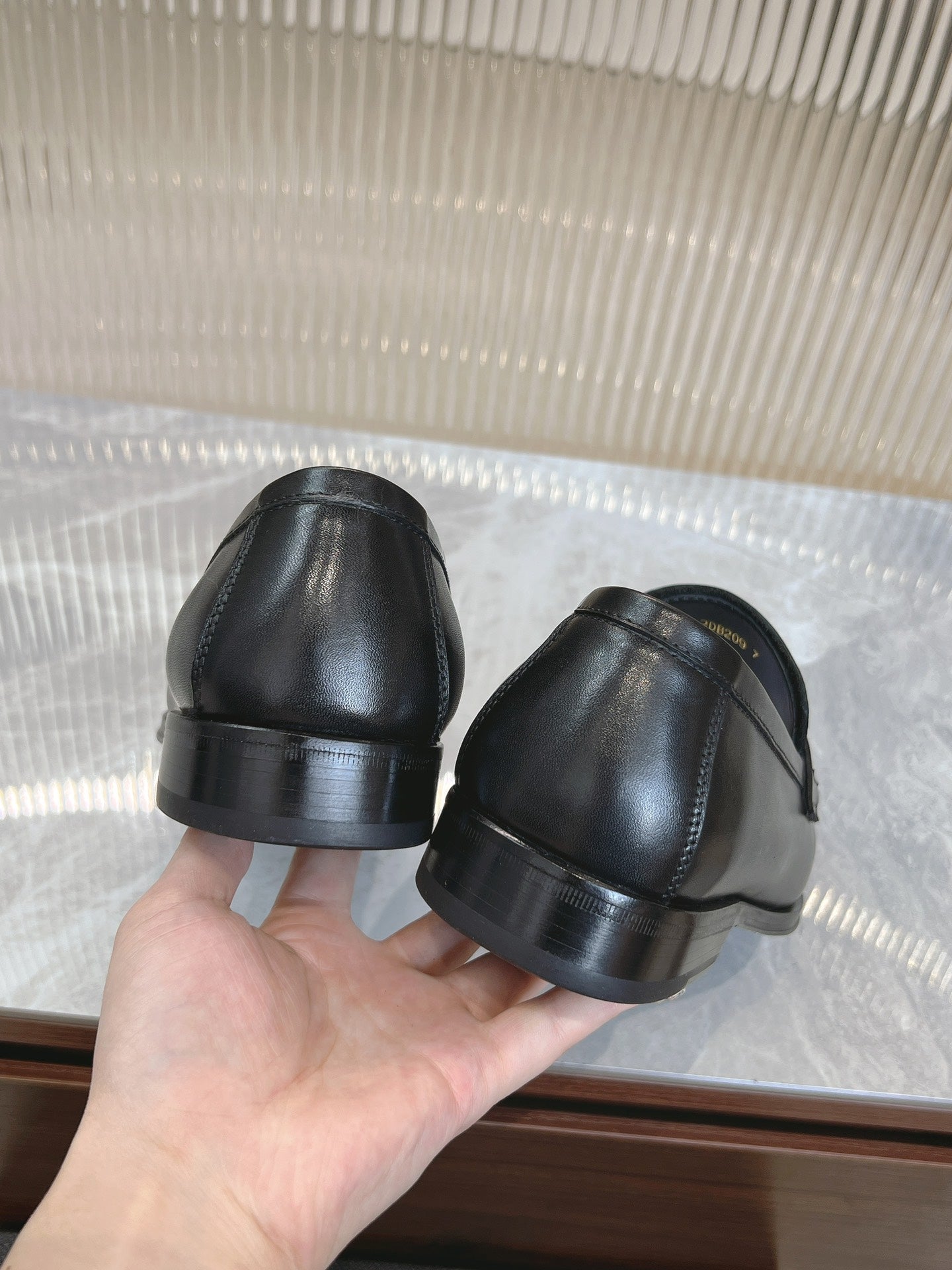 Black leather loafer heels shown, rounded back and ridged sole.