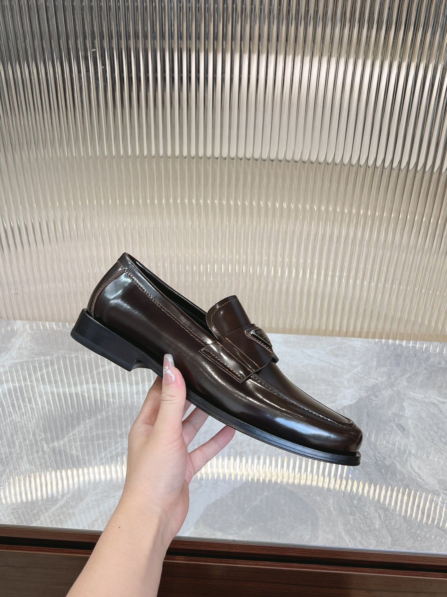 Dark brown leather Prada loafer with metal bit detail and low heel