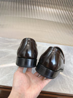 Dark brown leather Prada unisex loafers, view of rubber sole and heel