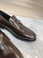 Dark brown leather Prada loafer with metal bit and stitched apron seam