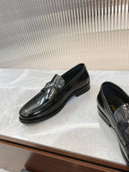 Prada unisex loafers in dark patent leather with metallic buckle, three-quarter view