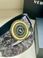 Versace belt close-up: gray floral strap and round gold Jeans Couture buckle