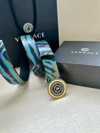 Versace belt buckle close-up on teal-blue patterned strap with round silver medallion