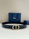 Dior belt with dark monogram strap and gold CD buckle, shown with gift bag