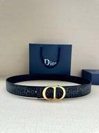 Dior belt with dark monogram strap and gold CD buckle, shown with gift bag