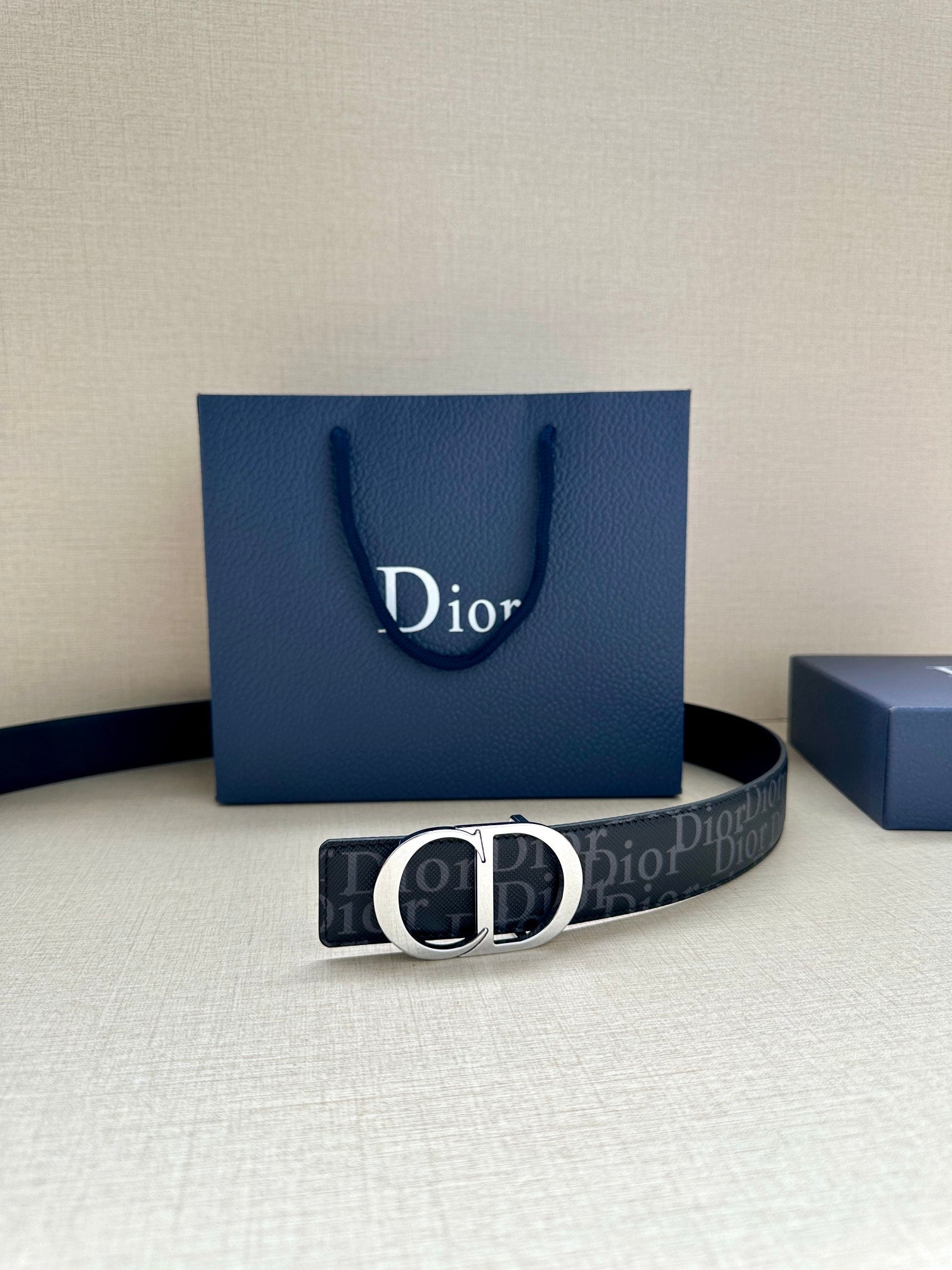 Dior belt with dark monogram strap and black CD buckle, with Dior shopping bag