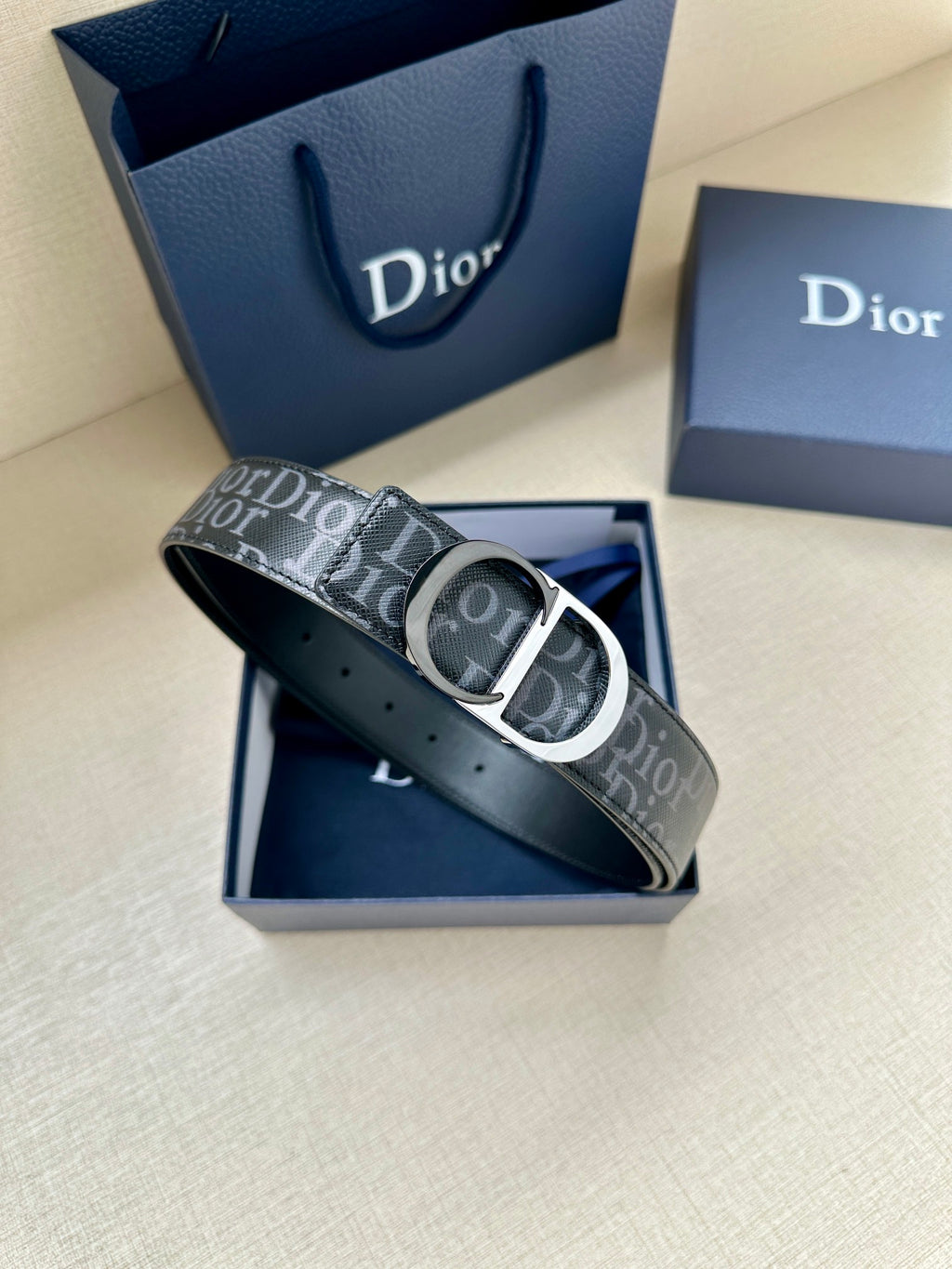 Dior Oblique belt angled view with silver CD buckle on dark patterned strap