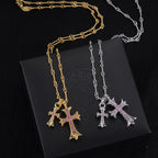 Gold and silver cross pendant necklaces with purple stone centers on linked chains