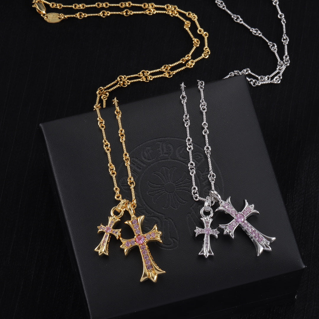 Gold and silver cross pendant necklaces with purple stone centers on linked chains