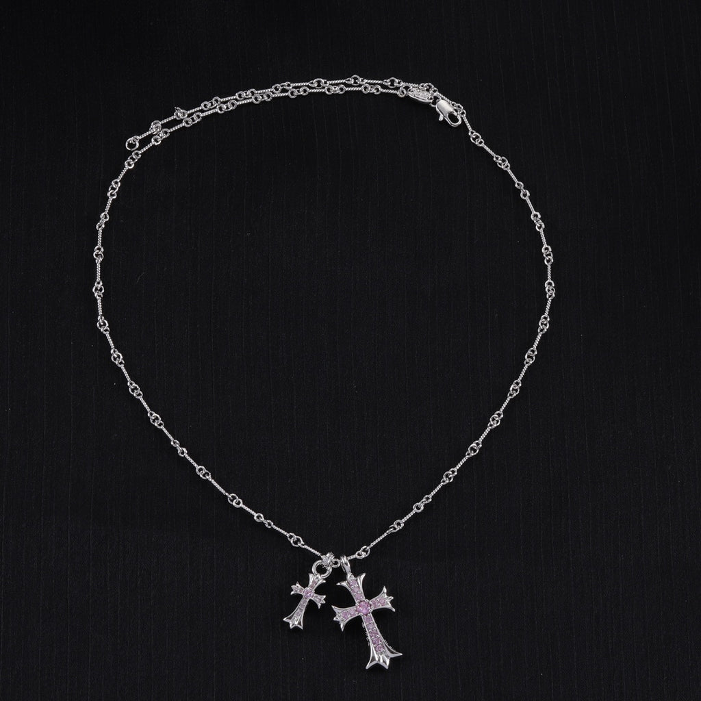 Silver cross pendant necklace with purple stone accents and linked chain