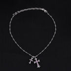 Silver cross pendant necklace with purple stone accents and linked chain
