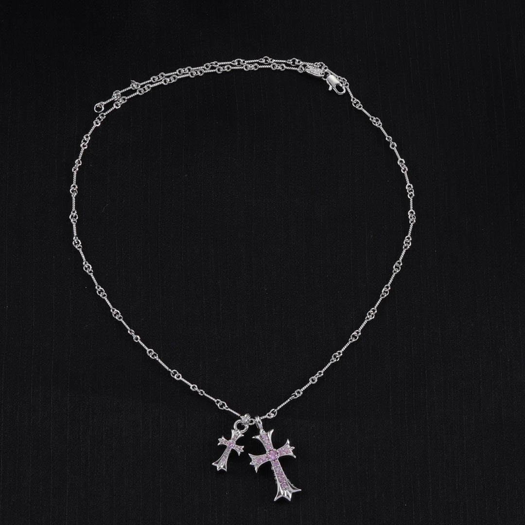 Silver cross pendant necklace with purple stone accents and linked chain