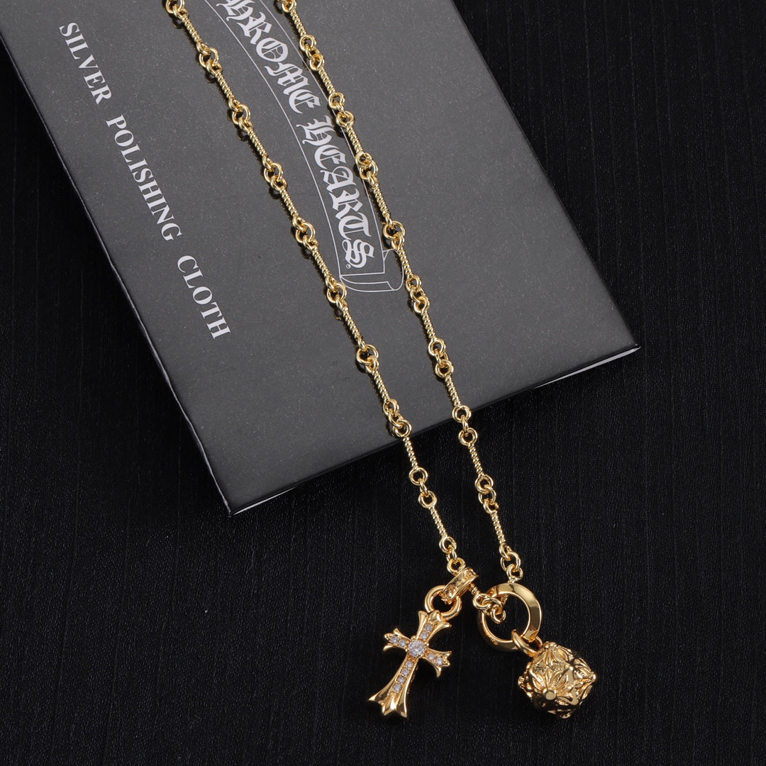 Gold-tone chain necklace with cross and star charms and round charm pendant