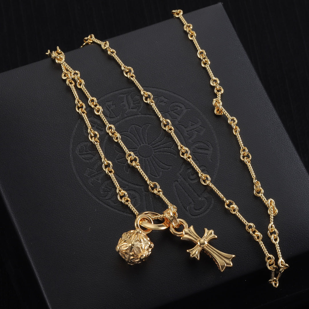Gold-tone pendant necklace set with round charm, cross, and star pendants