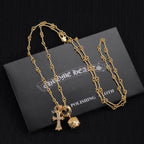 Gold-tone pendant necklace set with cross, star, and round charm pendants