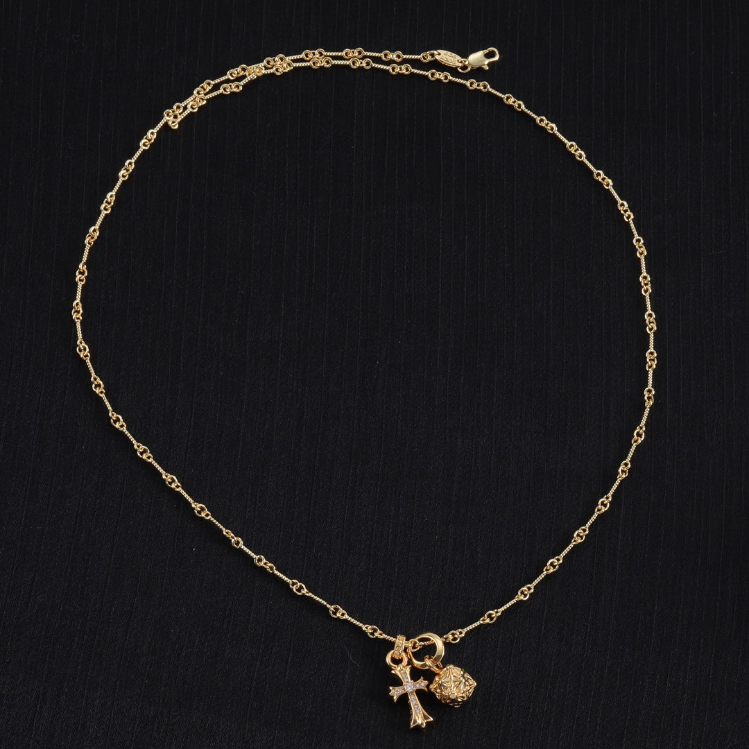 Gold-tone chain necklace with cross and round charm pendant