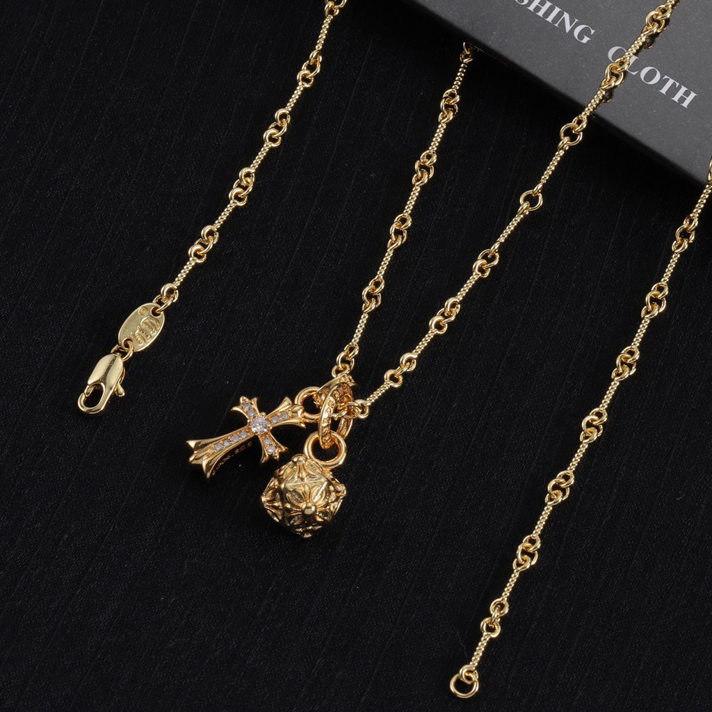 Gold-tone chain necklace set with cross, star, and round charm pendants