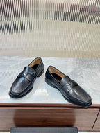 Prada unisex leather loafers, dark color, side view with strap detail