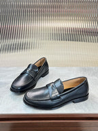 Prada unisex leather loafers, dark color, angled side view with strap detail
