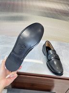 Prada unisex leather loafers, dark color; outsole and strap vamp visible