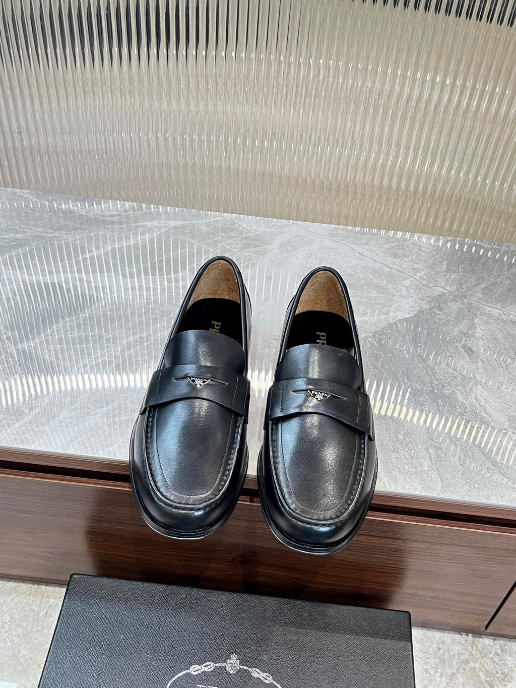 Prada unisex leather loafers, dark color, with strap detail and low heel