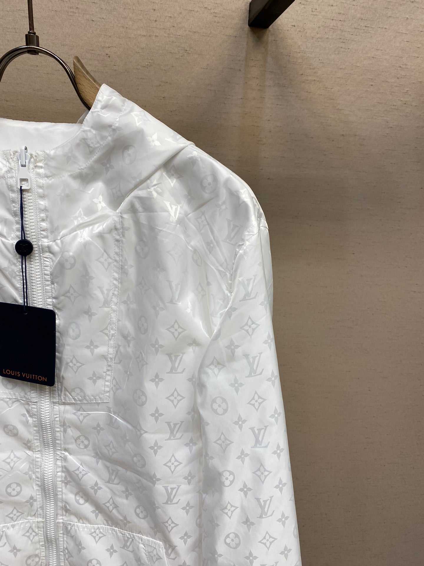 Louis Vuitton white monogram hooded zip jacket close-up on sleeve and shoulder