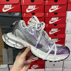Unisex sneakers front 3/4 view with metallic silver upper and purple logo panel