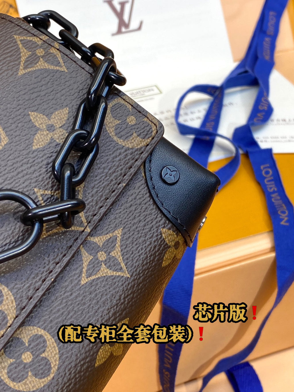 Louis Vuitton monogram crossbody bag close-up of chain handle and leather tab