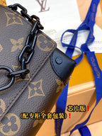 Louis Vuitton monogram crossbody bag close-up of chain handle and leather tab