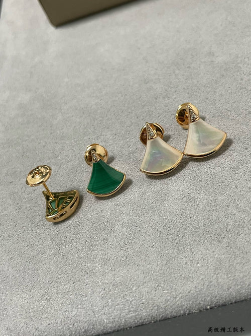 Bvlgari earrings set: gold half-moon studs with iridescent white and green enamel.
