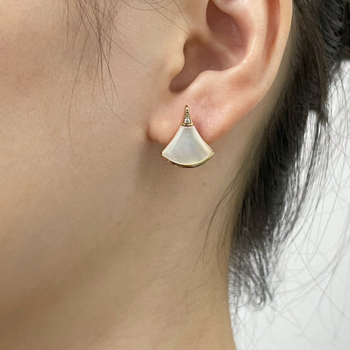 Bvlgari earrings: gold half-moon stud with iridescent white finish.
