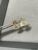 Bvlgari earrings: gold half-moon studs with iridescent white panels.