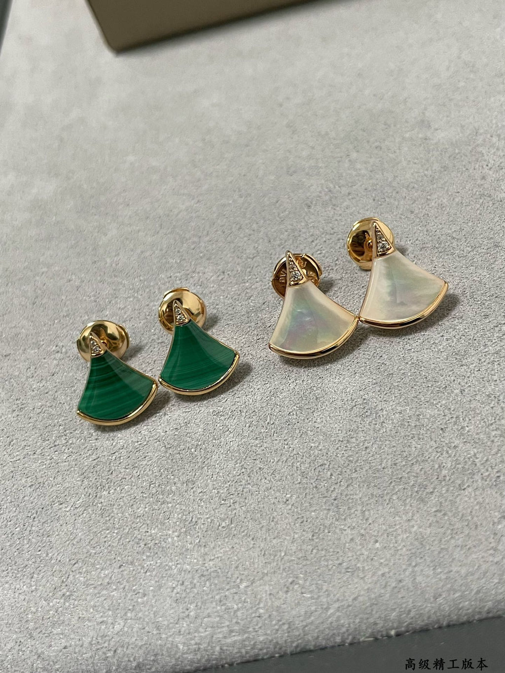 Bvlgari earrings set: gold half-moon studs with iridescent white and green enamel.