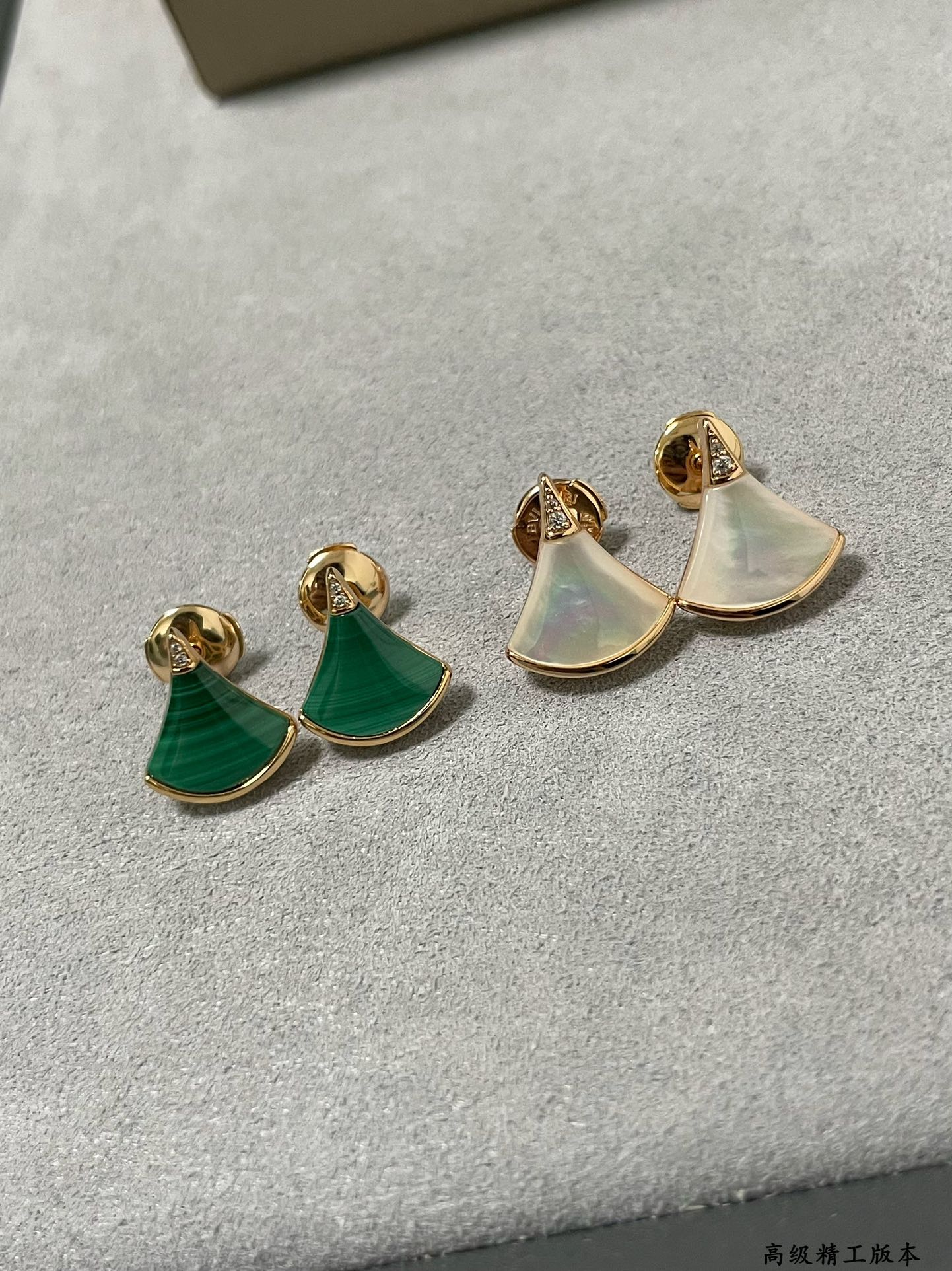 Bvlgari earrings set: gold half-moon studs with iridescent white and green enamel.