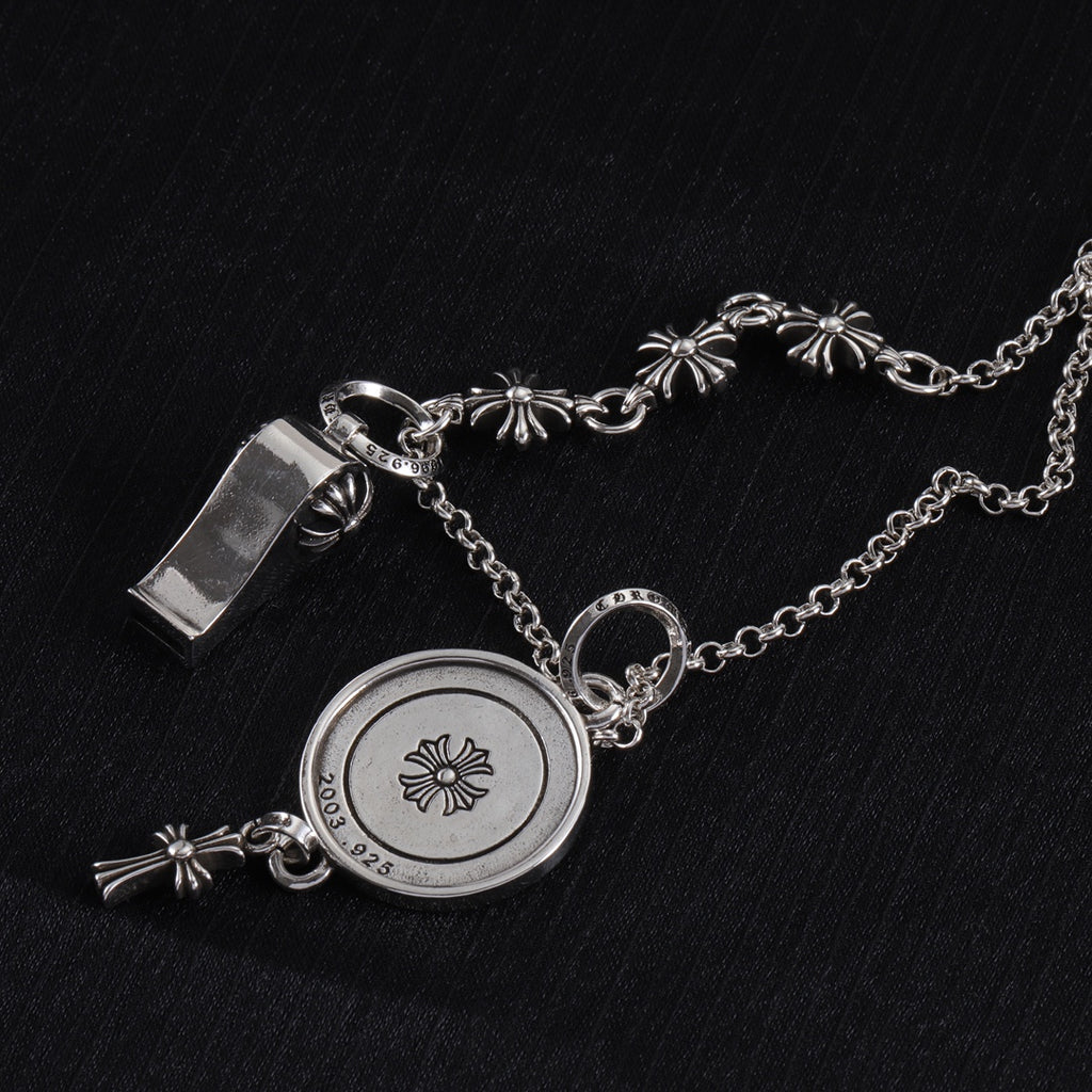 Silver-tone round locket charm necklace with etched butterfly design and fleur-de-lis accents