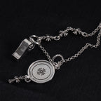 Silver-tone round locket charm necklace with etched butterfly design and fleur-de-lis accents