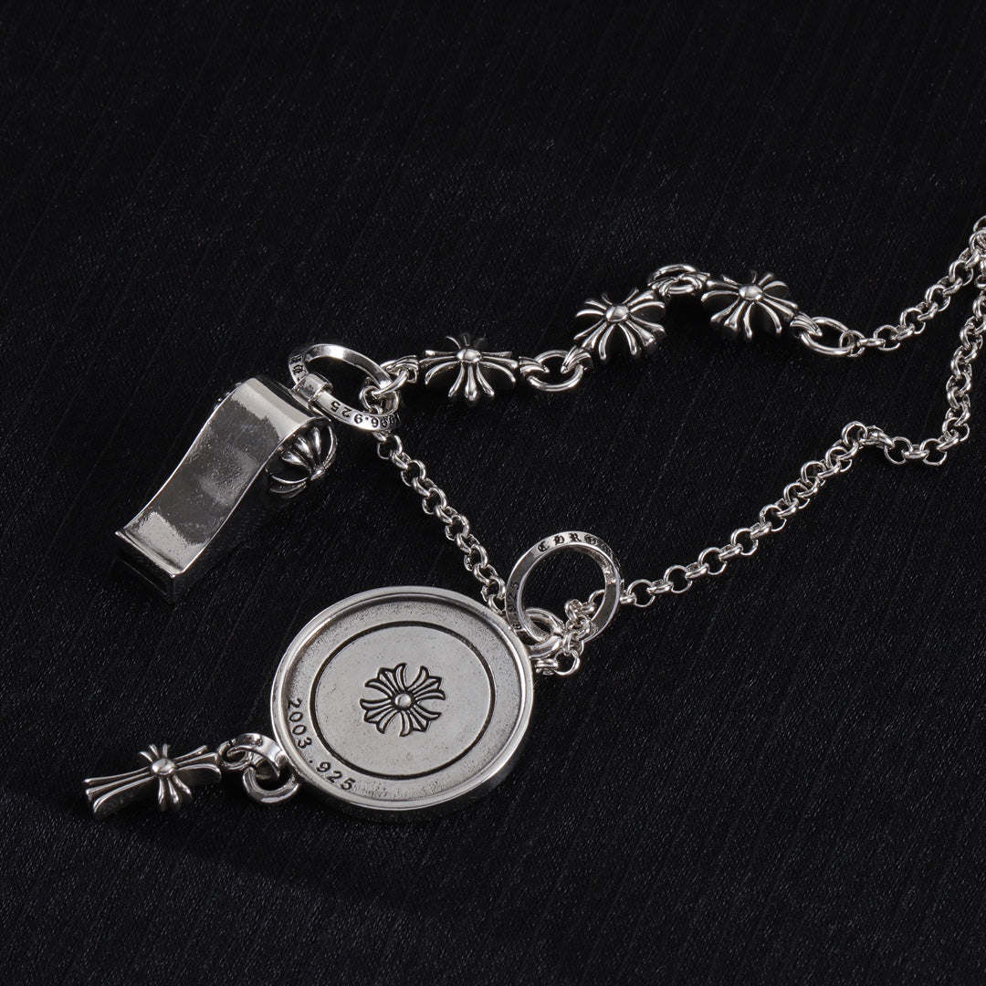 Silver-tone round locket charm necklace with etched butterfly design and fleur-de-lis accents