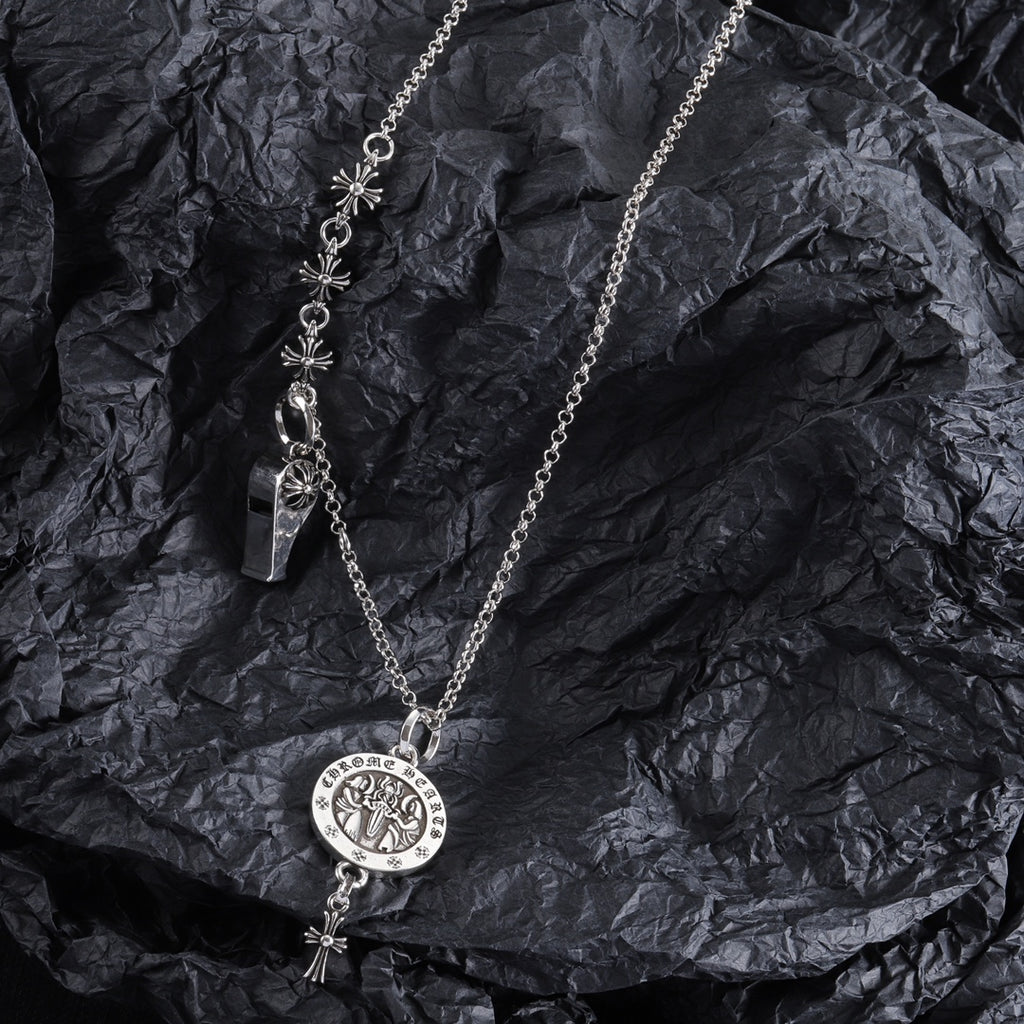 Silver-tone charm necklace with round medallion pendant, fleur-de-lis links, and small key charm