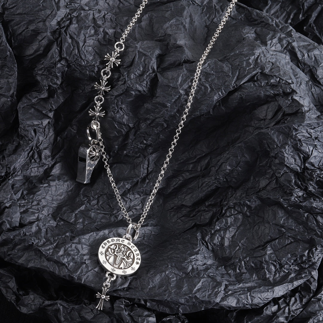 Silver-tone charm necklace with round medallion pendant, fleur-de-lis links, and small key charm