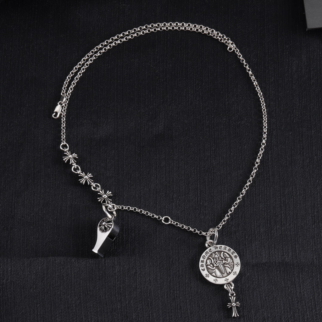Silver-tone charm necklace with round medallion pendant, star accents, and dangling detail