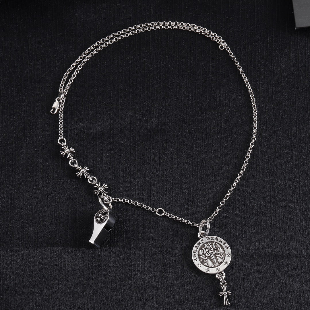 Silver-tone charm necklace with round medallion pendant, star accents, and dangling detail
