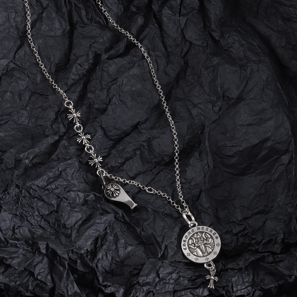 Silver-tone charm necklace with round medallion pendant and fleur-de-lis link accents