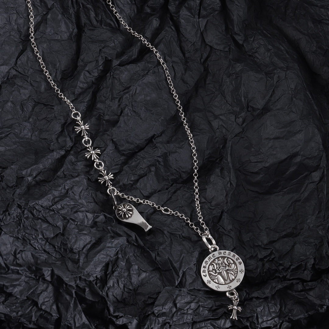 Silver-tone charm necklace with round medallion pendant and fleur-de-lis link accents