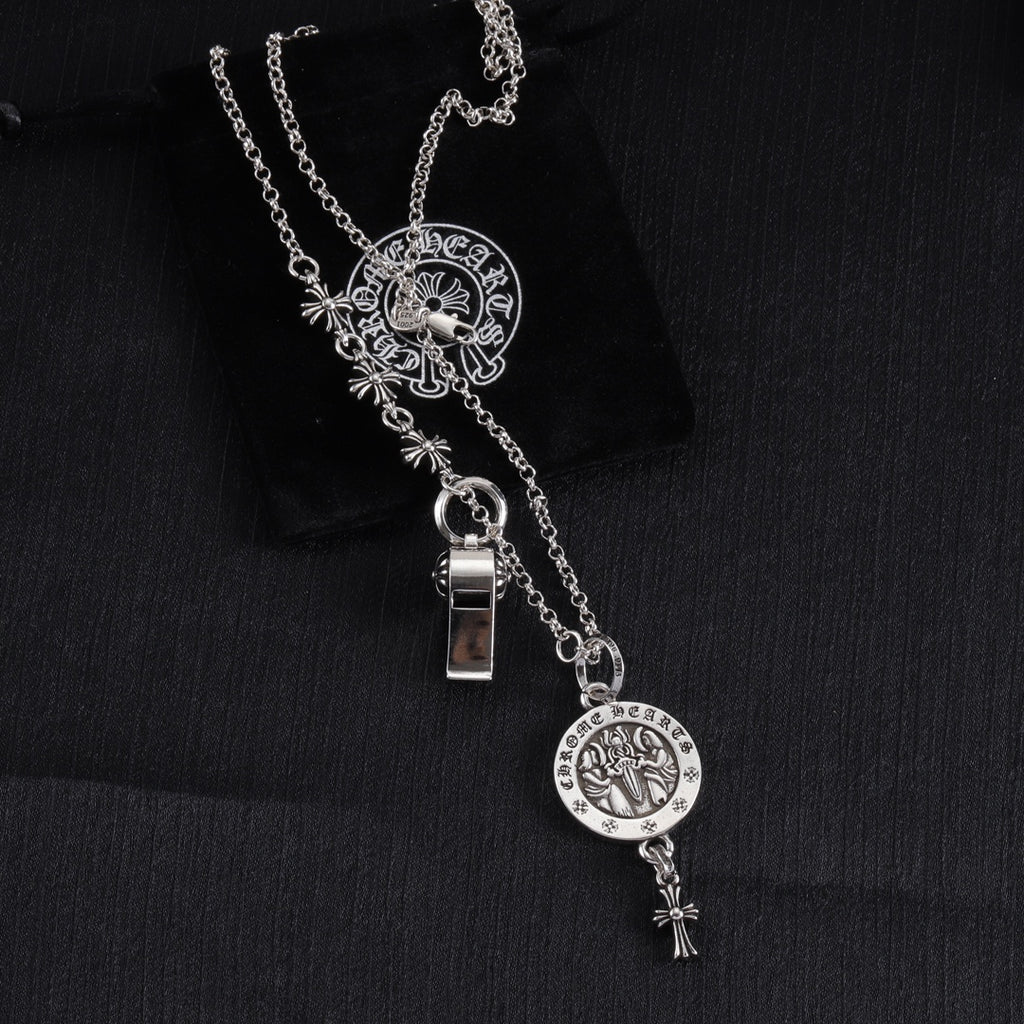 Silver-tone charm necklace with round medallion, fleur-de-lis motifs, and small metal lock charm
