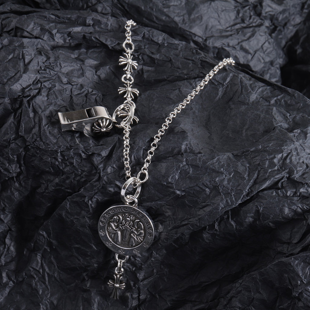 Silver-tone locket charm necklace with round pendant and hanging fleur-de-lis cross accents