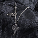 Silver-tone locket charm necklace with round pendant and hanging fleur-de-lis cross accents