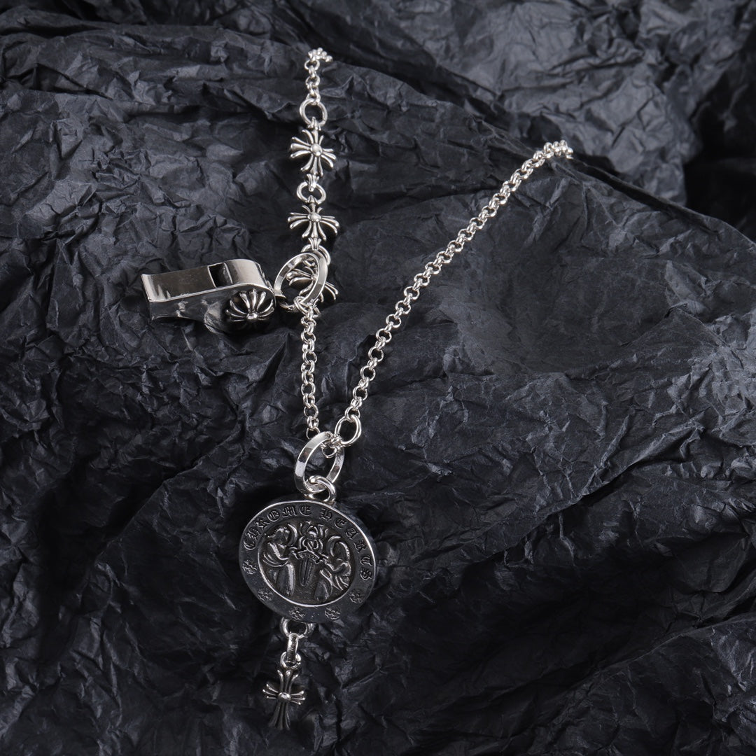 Silver-tone locket charm necklace with round pendant and hanging fleur-de-lis cross accents